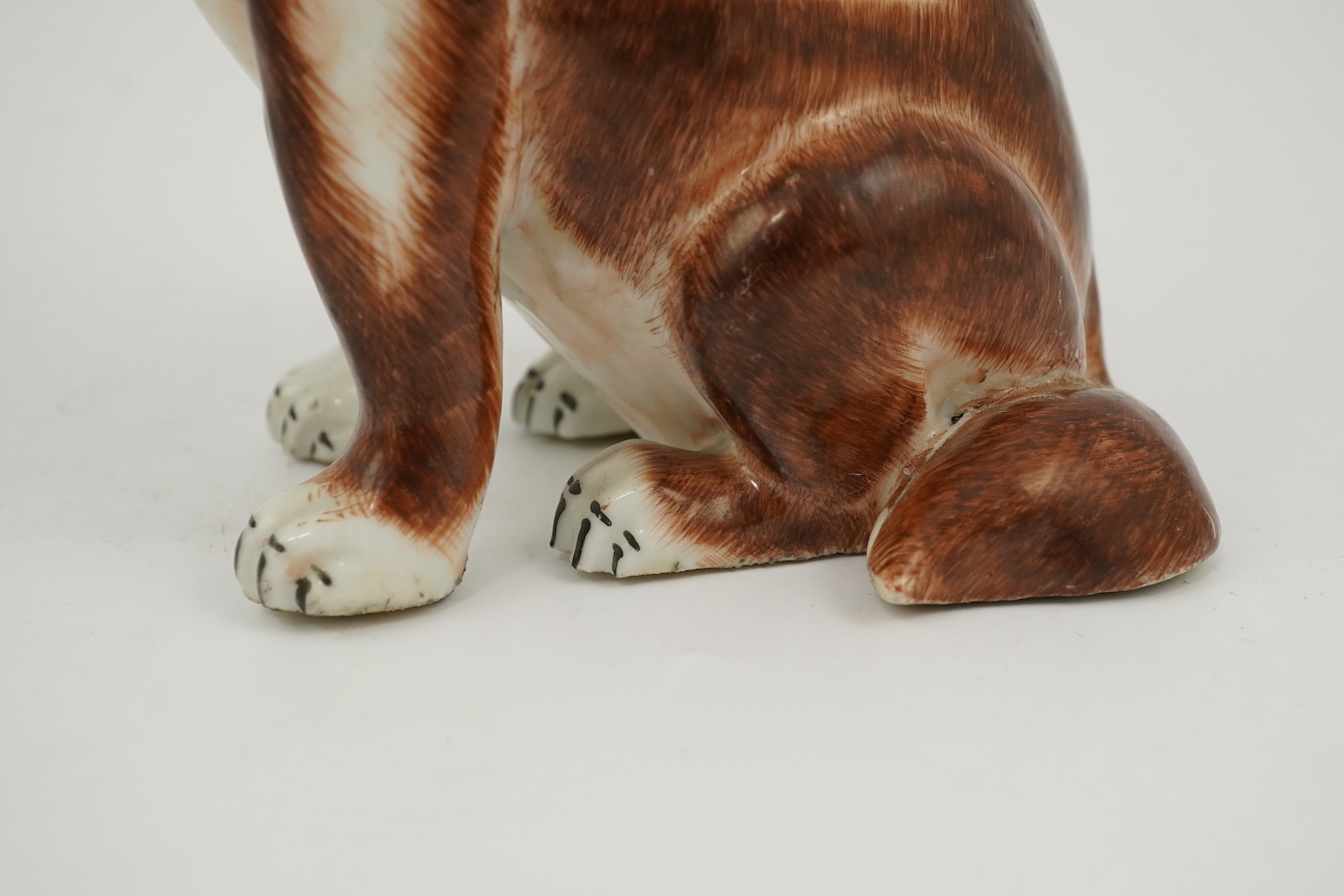 A Chinese export enamelled porcelain model of a seated spaniel, Qianlong period